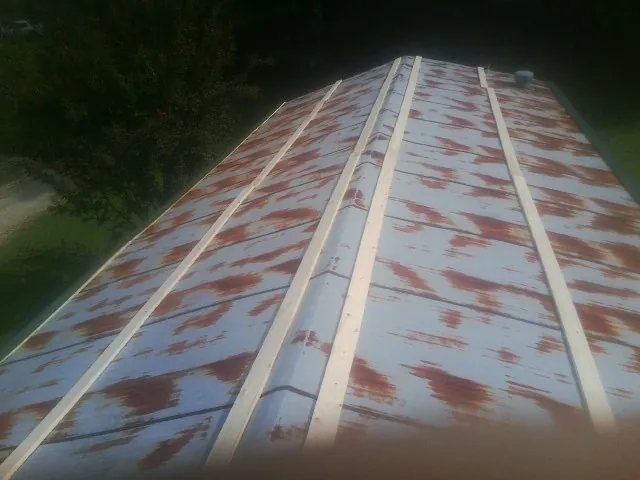 Rusted metal roof panels with new wood purlins before replacement — Storm Damage Roof Repair in Wurtsboro by Roofing Brothers