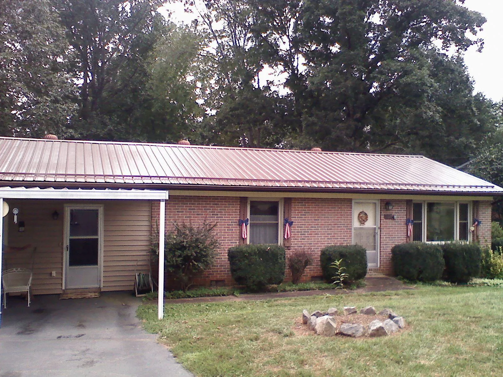 Bronze metal roof and carport on a brick ranch home — Roof Repair work by our crew in Wurtsboro